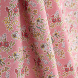 Percal estampado com ramos de flores sobre fundo rosa - Ribes y Casals