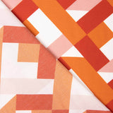 Viscose estampada com motivos geométricos em laranja e coral - Ribes y Casals